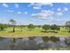 Picturesque golf course view with lush greenery and water features, ideal for recreation at 7461 W Country Club Dr N # 408, Sarasota, FL 34243