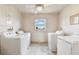 Bright laundry room featuring multiple machines and a window for natural light at 7461 W Country Club Dr N # 408, Sarasota, FL 34243