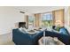 Inviting living room featuring comfortable sofas and a scenic balcony at 7461 W Country Club Dr N # 408, Sarasota, FL 34243
