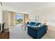 Bright living room with balcony, neutral carpet, and comfortable seating at 7461 W Country Club Dr N # 408, Sarasota, FL 34243