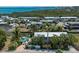 Aerial shot of a coastal community with a home featuring a backyard pool and canal access at 750 Tarawitt Dr, Longboat Key, FL 34228