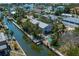 Aerial view of a home with canal access, lush greenery, and a backyard pool at 750 Tarawitt Dr, Longboat Key, FL 34228