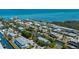 Coastal home aerial view featuring lush landscaping, canal access, and neighborhood views at 750 Tarawitt Dr, Longboat Key, FL 34228