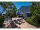 Lush backyard featuring a patio, pool, outdoor seating, and well-maintained landscaping at 750 Tarawitt Dr, Longboat Key, FL 34228