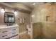 Elegant bathroom with modern vanity, stylish mirror, and glass-enclosed shower featuring neutral tile at 750 Tarawitt Dr, Longboat Key, FL 34228