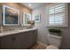 Well-lit bathroom with dual sinks, modern mirrors, and wood-look accent wall for a spa-like feel at 750 Tarawitt Dr, Longboat Key, FL 34228