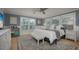 Cozy bedroom features shuttered windows, hardwood floors, soft textures, and a ceiling fan at 750 Tarawitt Dr, Longboat Key, FL 34228
