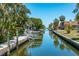 Beautiful canal view, complemented by tropical plants and boat lift at 750 Tarawitt Dr, Longboat Key, FL 34228