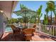 Charming deck featuring an outdoor dining area and wicker chairs, ideal for entertaining and enjoying tropical views at 750 Tarawitt Dr, Longboat Key, FL 34228