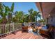 Inviting outdoor deck with comfortable seating, offering stunning views of lush greenery and clear skies at 750 Tarawitt Dr, Longboat Key, FL 34228