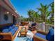 Expansive deck with stylish outdoor seating, perfect for relaxing and enjoying the serene, tropical surroundings at 750 Tarawitt Dr, Longboat Key, FL 34228