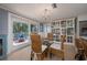 Charming dining area with a glass table, woven chairs, and view of the outdoor deck at 750 Tarawitt Dr, Longboat Key, FL 34228