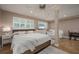 Bright main bedroom featuring a king-size bed, ceiling fan, and natural light from windows with charming shutters at 750 Tarawitt Dr, Longboat Key, FL 34228
