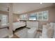 Comfortable main bedroom with white furnishings, sitting area, and a serene ambiance for restful nights at 750 Tarawitt Dr, Longboat Key, FL 34228