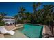 Beautiful backyard pool and spa surrounded by lush tropical landscaping, offering a private oasis at 750 Tarawitt Dr, Longboat Key, FL 34228