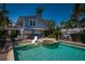 Gorgeous pool and patio with a hot tub, lounge chairs, and tropical ambiance at 750 Tarawitt Dr, Longboat Key, FL 34228