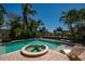 Beautiful pool area with spa, lounge chairs, and tranquil canal views at 750 Tarawitt Dr, Longboat Key, FL 34228