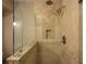 Shower with neutral tiling, glass enclosure and built-in niche at 750 Tarawitt Dr, Longboat Key, FL 34228