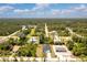 An aerial view shows the property's setting with its adjacent homes surrounded by a stunning tree canopy at 7852 Tasco Dr, North Port, FL 34291