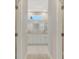 A glimpse through the doorway into the bathroom revealing a vanity with double sinks and a shower at 7852 Tasco Dr, North Port, FL 34291