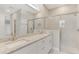 Bathroom view highlighting a vanity with double sinks, granite countertops, and a modern glass-enclosed shower at 7852 Tasco Dr, North Port, FL 34291