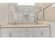 Bathroom showcasing a spacious vanity with double sinks, granite countertop, and a frameless glass shower enclosure at 7852 Tasco Dr, North Port, FL 34291