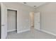 A spacious bedroom with gray walls, carpeted floor, walk in closet, and connecting door at 7852 Tasco Dr, North Port, FL 34291
