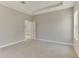 This is a well-lit main bedroom with neutral walls, carpet flooring, and a doorway leading to an adjacent space at 7852 Tasco Dr, North Port, FL 34291