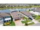 Beautiful home boasts a well-manicured lawn, lush landscaping, brick driveway and views of a tranquil pond in a desirable community at 7859 Yale Harbor Dr, Wesley Chapel, FL 33545