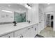 Bathroom featuring double sinks, modern fixtures, and a glass-enclosed shower at 7859 Yale Harbor Dr, Wesley Chapel, FL 33545