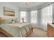 Bright bedroom featuring a comfortable bed and bay window with natural light and neutral decor at 7859 Yale Harbor Dr, Wesley Chapel, FL 33545