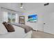 Bright bedroom featuring a white dresser, large windows, and a ceiling fan at 7859 Yale Harbor Dr, Wesley Chapel, FL 33545