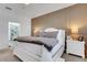 Bedroom featuring white furniture, neutral colors, and an ensuite bathroom at 7859 Yale Harbor Dr, Wesley Chapel, FL 33545