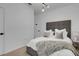 Bedroom featuring a gray upholstered headboard with comfortable pillows and a plush throw at 7859 Yale Harbor Dr, Wesley Chapel, FL 33545