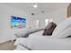 Comfortable bedroom with a white bed, TV, and a view to the Primary bath at 7859 Yale Harbor Dr, Wesley Chapel, FL 33545