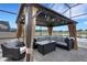 Relaxing gazebo with comfortable seating and a view of the lake at 7859 Yale Harbor Dr, Wesley Chapel, FL 33545