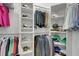 Organized walk-in closet with built-in shelving, hanging rods, and shoe racks at 7859 Yale Harbor Dr, Wesley Chapel, FL 33545