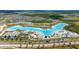 Beautiful community with a large crystal lagoon, waterslides, and a sandy beach, offering a resort-style living experience at 7859 Yale Harbor Dr, Wesley Chapel, FL 33545