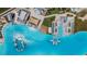 Top-down view of a lagoon community pool featuring water park elements, a poolside bar, and ample seating at 7859 Yale Harbor Dr, Wesley Chapel, FL 33545