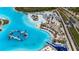 Birds-eye view of a community lagoon pool that offers a beach, water slide, and other water-based activities at 7859 Yale Harbor Dr, Wesley Chapel, FL 33545