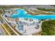 Aerial shot of a community with a lagoon-style pool, sandy beach areas, and water park elements for residents at 7859 Yale Harbor Dr, Wesley Chapel, FL 33545