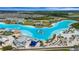 Stunning aerial view of the crystal lagoon showcasing sandy beaches, water slides, and crystal clear water in a resort community at 7859 Yale Harbor Dr, Wesley Chapel, FL 33545
