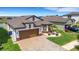 Beautiful aerial view of a home with manicured lawn and stylish brick driveway at 7859 Yale Harbor Dr, Wesley Chapel, FL 33545