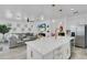 Open floorplan featuring a kitchen island, stainless appliances, and a view into the living room at 7859 Yale Harbor Dr, Wesley Chapel, FL 33545