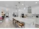 Bright kitchen featuring white cabinetry, stainless steel appliances, and an island with bar seating at 7859 Yale Harbor Dr, Wesley Chapel, FL 33545