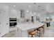 Modern kitchen with white cabinets, stainless steel appliances, and a center island with barstool seating at 7859 Yale Harbor Dr, Wesley Chapel, FL 33545