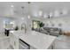 Open concept living room and kitchen with a large island and comfortable seating area at 7859 Yale Harbor Dr, Wesley Chapel, FL 33545