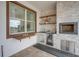 Modern outdoor kitchen with stone finishes, built-in appliances, and bar seating at 7859 Yale Harbor Dr, Wesley Chapel, FL 33545