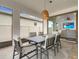 Cozy outdoor dining area with stylish furniture and view to living room at 7859 Yale Harbor Dr, Wesley Chapel, FL 33545