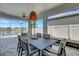 Screened patio with a dining table, overlooking a pool and lake at 7859 Yale Harbor Dr, Wesley Chapel, FL 33545
